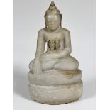 A carved alabaster seated figure of Buddha seated on lotus leaf moulded and carved base, traces of