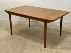 McIntosh, a mid century teak extending dining table, the top opening to two magic leaves, raised