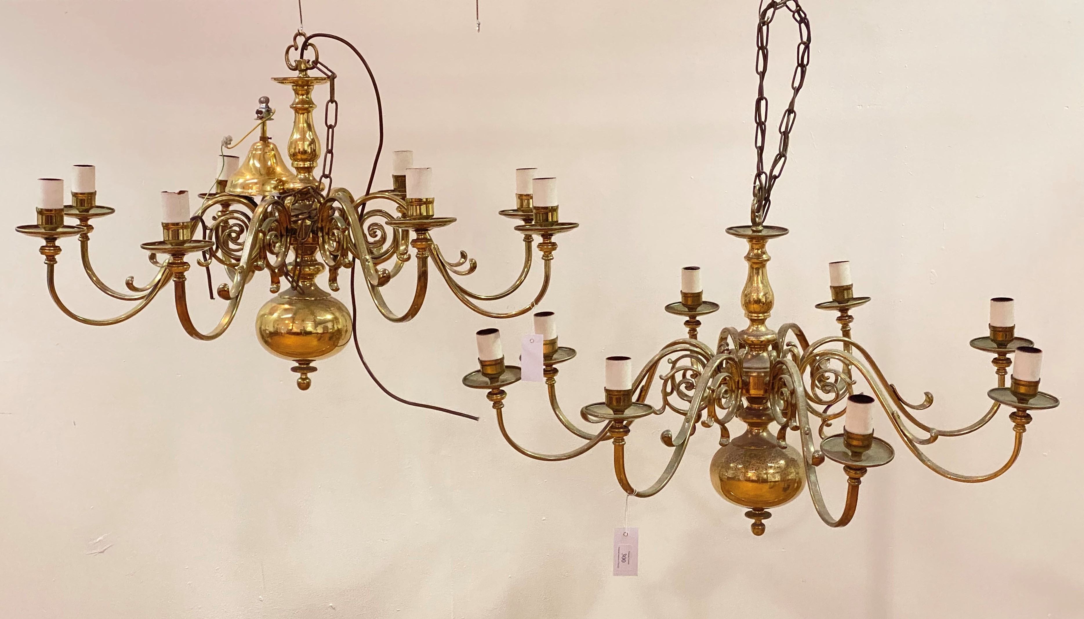 A pair of mid to late 20th century Dutch style laquered brass chandeliers, with eight scrolling