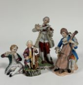 A group of four Continental porcelain figurers each playing various instruments such as violin,