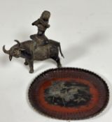 A brass metal Thai/Sri Lankan figure playing an instrument seated on a water buffalo (h - 19cm w-