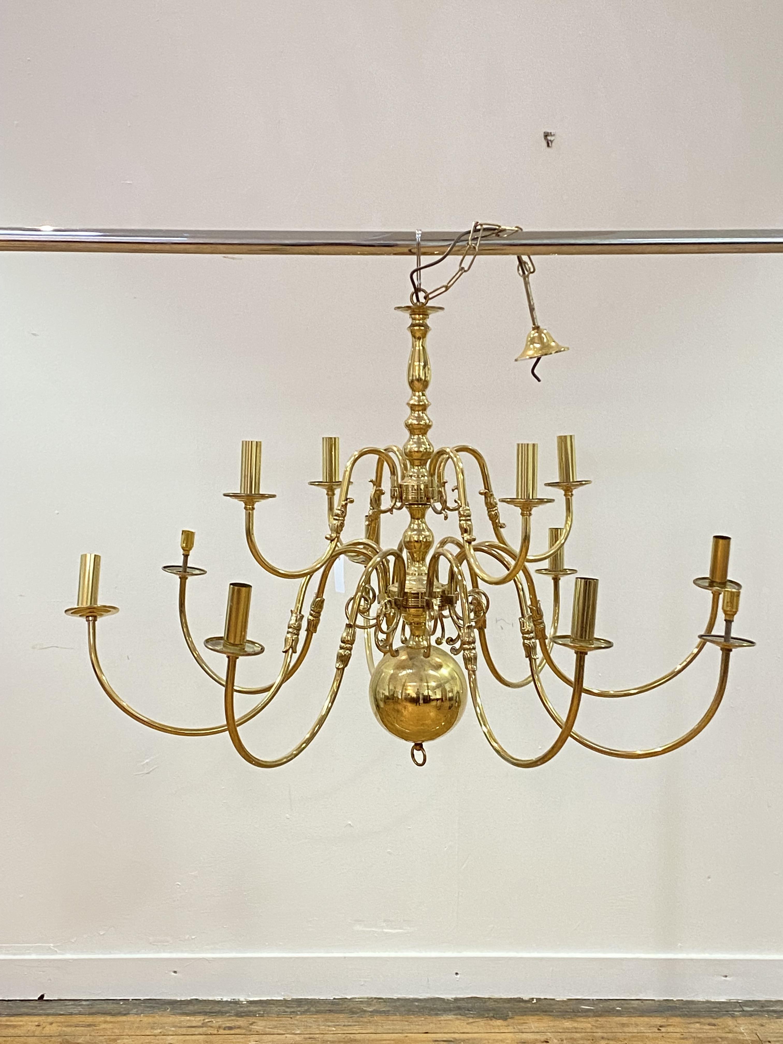 A Dutch style brass chandelier, with twelve scrolling branches D113cm