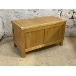 A contemporary solid hardwood blanket box with two panel front on stile supports, H50cm, W85cm,