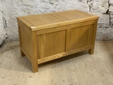 A contemporary solid hardwood blanket box with two panel front on stile supports, H50cm, W85cm,