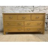 A contemporary solid hardwood multidrawer sideboard, fitted with three short and four long