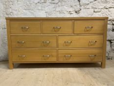 A contemporary solid hardwood multidrawer sideboard, fitted with three short and four long