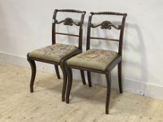 A pair of early 20th century stained mahogany chairs of Regency design, the brass mounted turned