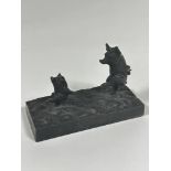 A Continental cast iron rectangular figure group of two dancing pigs on naturalistic base (6.5cm x