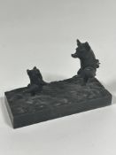 A Continental cast iron rectangular figure group of two dancing pigs on naturalistic base (6.5cm x