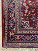 A Persian Kashan rug, the busy red field within a multi line border, moth damage 335cm x 233cm
