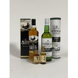 A 70cl bottle of Black Grouse blended Scotch Whisky, a 70cl bottle of Laphroaig islay single malt