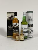 A 70cl bottle of Black Grouse blended Scotch Whisky, a 70cl bottle of Laphroaig islay single malt