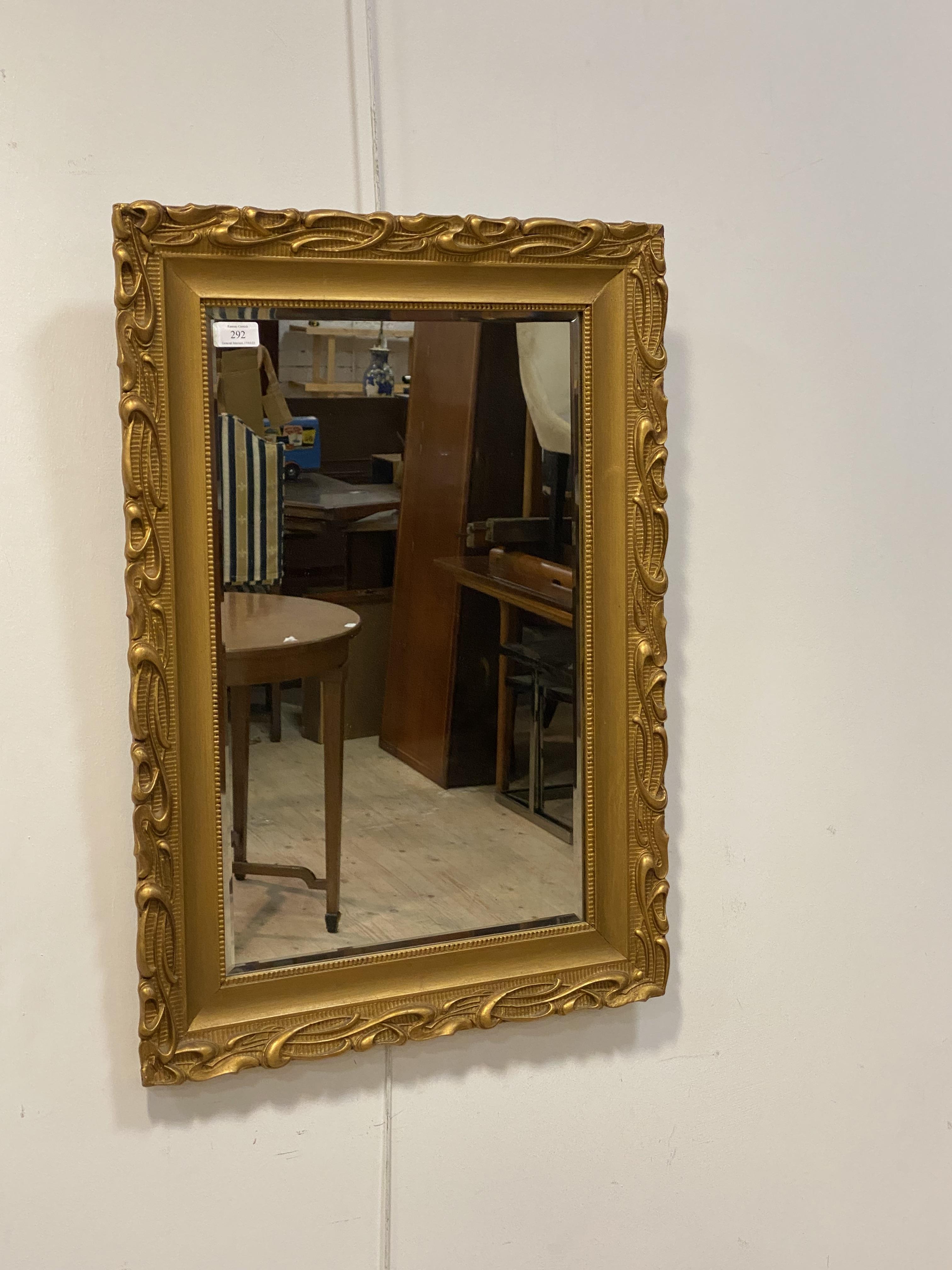 A gilt painted composition framed wall mirror, with bevelled glass plate, 77cm x 55cm