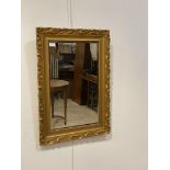 A gilt painted composition framed wall mirror, with bevelled glass plate, 77cm x 55cm