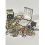 A collection of costume jewellery including marcasite circular brooch and floral spray brooch, a