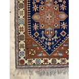 A Caucasian hand knotted runner, the deep blue field with pole medallion framed within an ivory