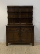 Ercol, a stained elm dresser, with three height plate rack over two drawers and twin cupboard,