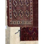 A Turkoman hand knotted bag face rug, typically decorated with guls, (112cm x 77cm) together with