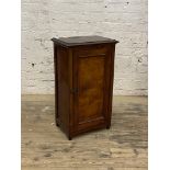 An Edwardian walnut cabinet, panelled door enclosing shelves, H81cm, W48cm, D32cm