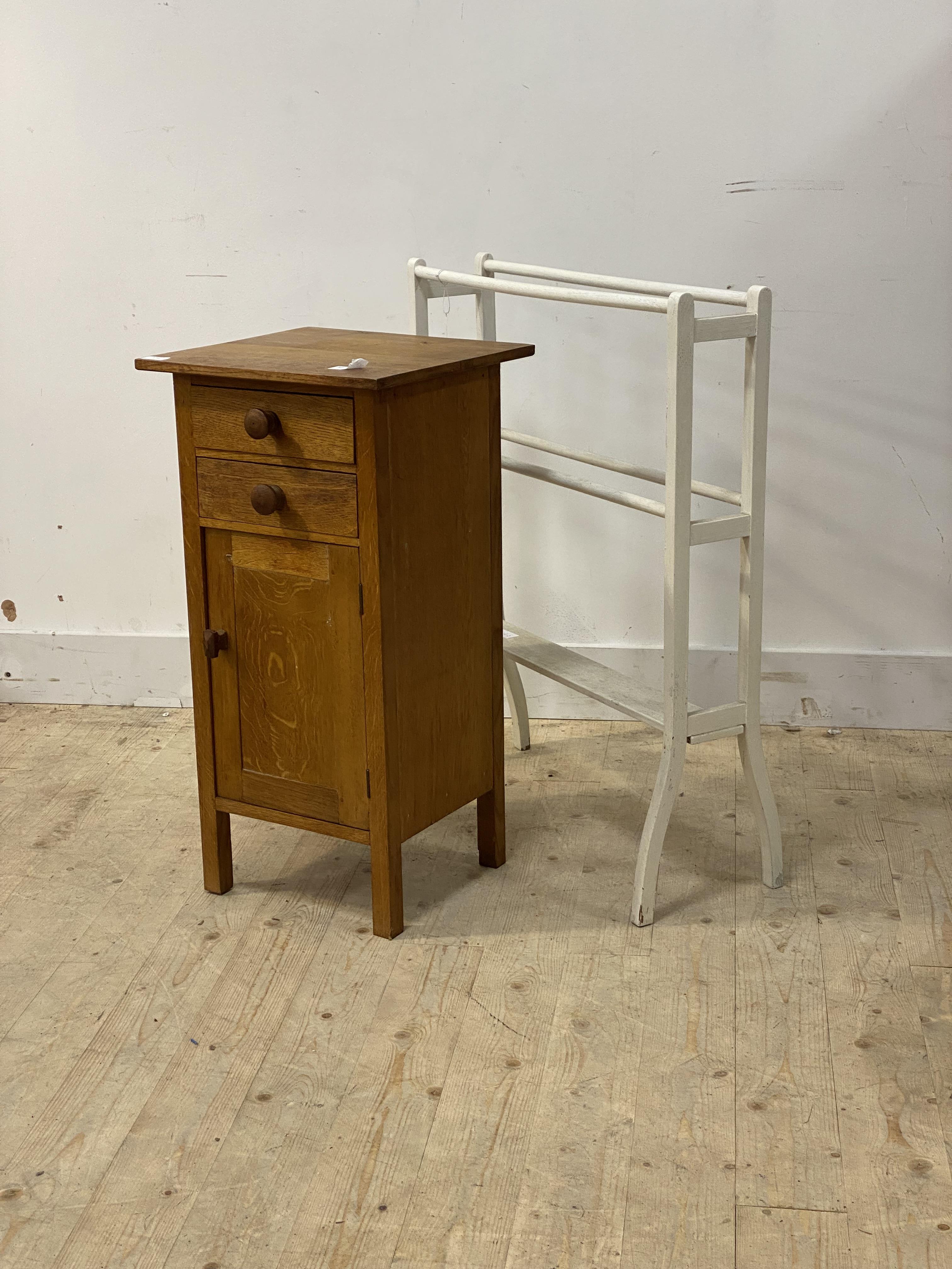 An oak bedside cabinet fitted with two drawers and cupboard on stile supports, (H79cm) together with