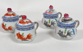 A set of four Herend porcelain cups and covers with peach knops, decorated with koy carp (5.5cm