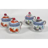 A set of four Herend porcelain cups and covers with peach knops, decorated with koy carp (5.5cm