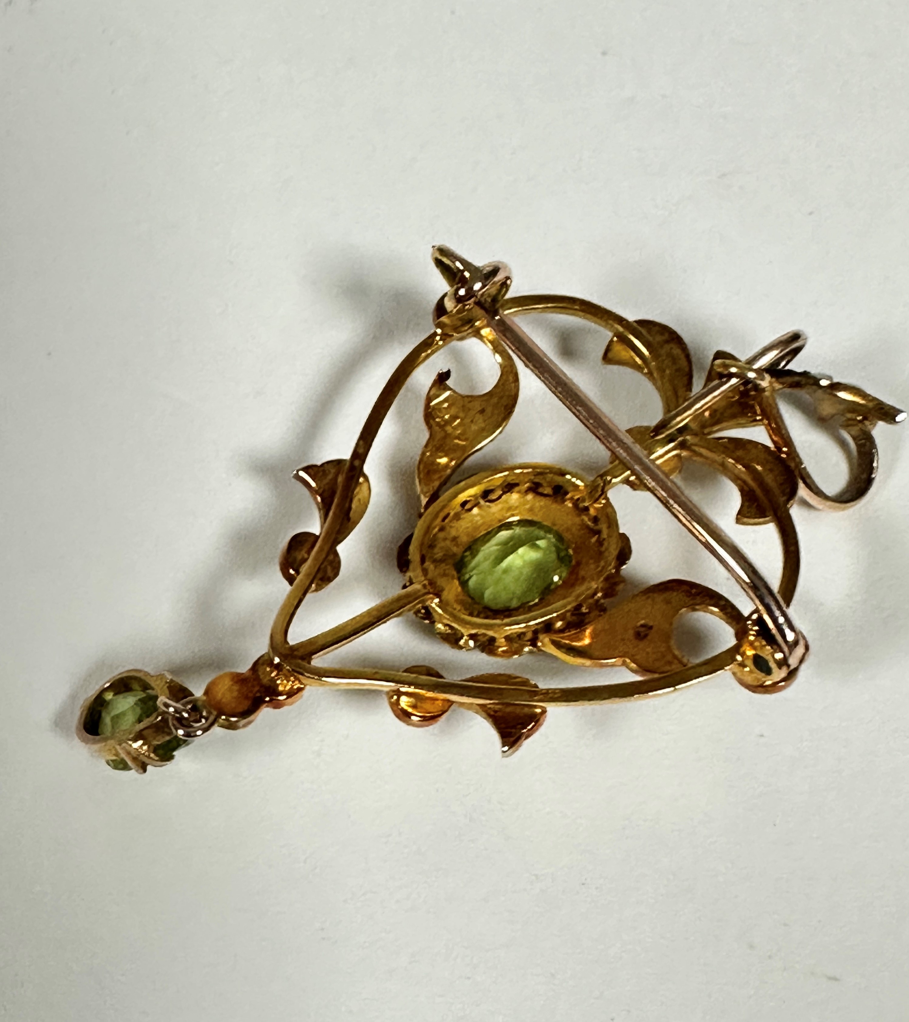 An Edwardian 9ct gold open work brooch pendant set of heart shape, set central oval peridot, set - Image 2 of 3
