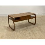 Parker Knoll, a mid century teak coffee table, fitted with drawer and under tier raised on shaped