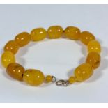 An amber bead necklace of yoke colour, (each bead 3cm x 2cm, total length 39cm) (119.3g)