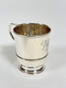 A Birmingham 1928 silver tapered cylinder christening cup with C scroll handle to side with engraved