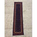 A Persian style runner rug, the blue field of repeating design 246cm x 59cm