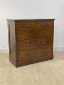 An Edwardian mahogany chest fitted with two short and three long graduated drawers, raised on