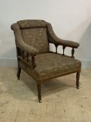 An Edwardian inlaid rosewood easy chair, upholstered seat back and open arms, raised on ring