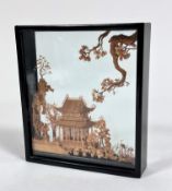 A glazed ebonised case carved balsa wood diorama of a Chinese Pagoda with stylised carved branches