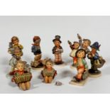 A collection of nine various Hummel pottery figures including Merry Wanderer, Easter Greetings, My