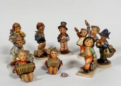 A collection of nine various Hummel pottery figures including Merry Wanderer, Easter Greetings, My