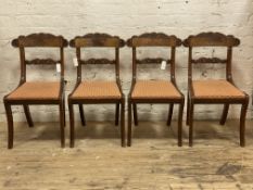 A set of four Regency mahogany dining chairs with acanthus scroll carved rail backs over drop in