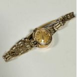 A lady's Verity yellow metal wristwatch, the dial on expanding yellow metal bracelet, (d 2cm) with