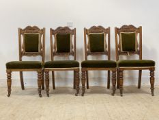 A set of four Edwardian oak dining chairs, acanthus carved crest rail, upholstered seat and back,