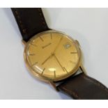 A Gents Bulover yellow metal wristwatch, the gilt dial with applied baton markers and date aperture,