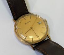 A Gents Bulover yellow metal wristwatch, the gilt dial with applied baton markers and date aperture,