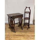 An early 20th century mahogany nest of three tables, each with moulded tops raised on supports of
