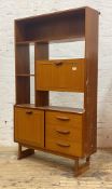 Stonehill, A Stateroom mid century teak combination etagere, with open shelves, fall front