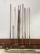 Fishing interest, a quantity of fishing rods (most incomplete) within an early 20th century fitted