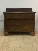 An Edwardian walnut ledge back chest, fitted with two short and two long drawers on bracket