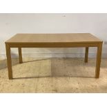 A contemporary extending dining table on square section supports, H74cm, 176cm x 96cm