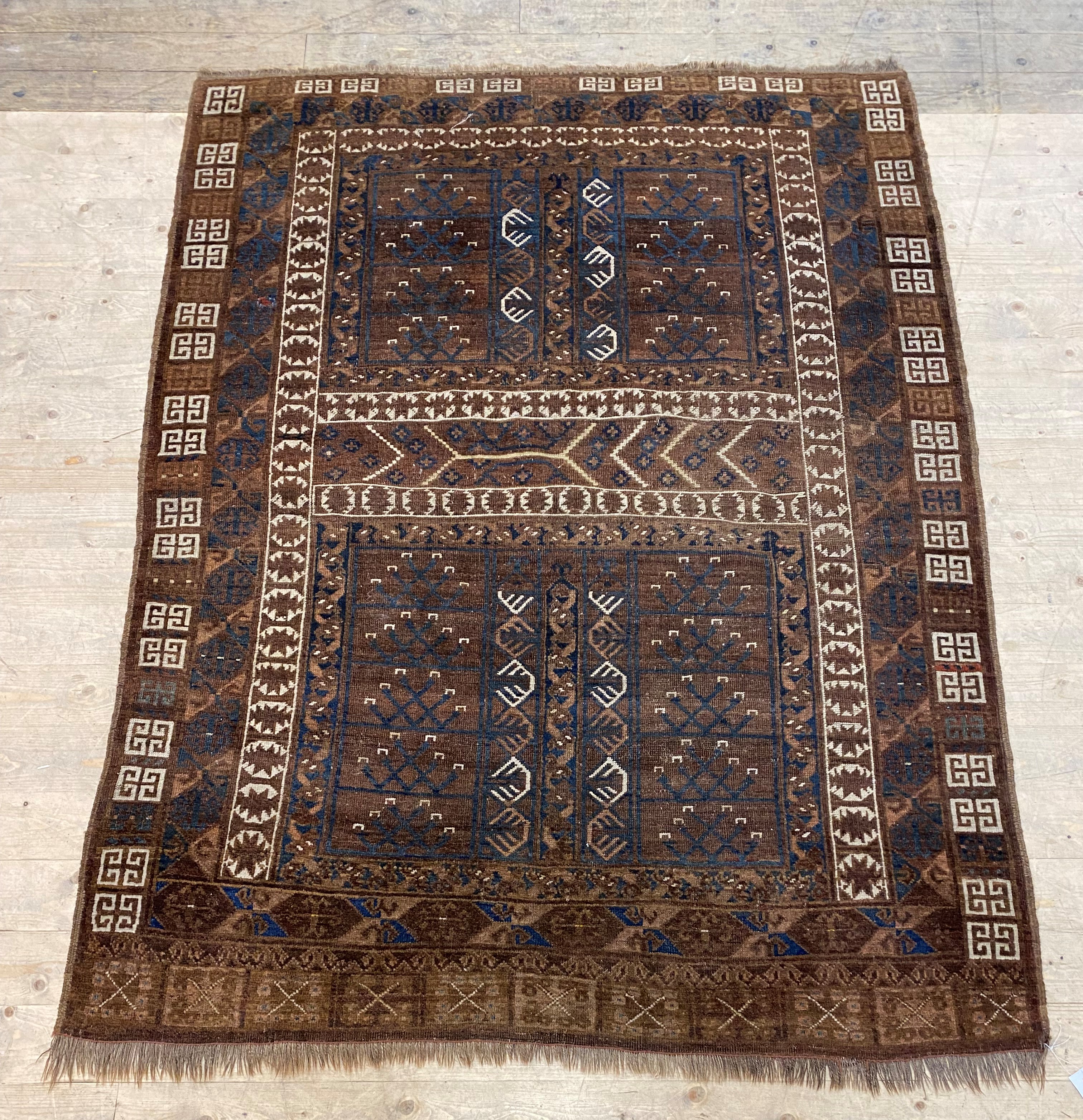 An Antique tribal Turkoman rug, of all over geometric design in browns, reds, blues and ivory - Image 2 of 2