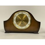 An Art Deco period walnut cased dome top mantle clock, the white and gilt dial with Arabic chapter