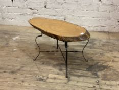 A vintage naturalistic low table, the varnished tree trunk cross section top raised on wrought