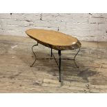 A vintage naturalistic low table, the varnished tree trunk cross section top raised on wrought